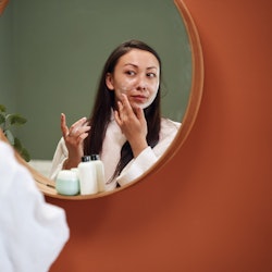 woman applying skin care products