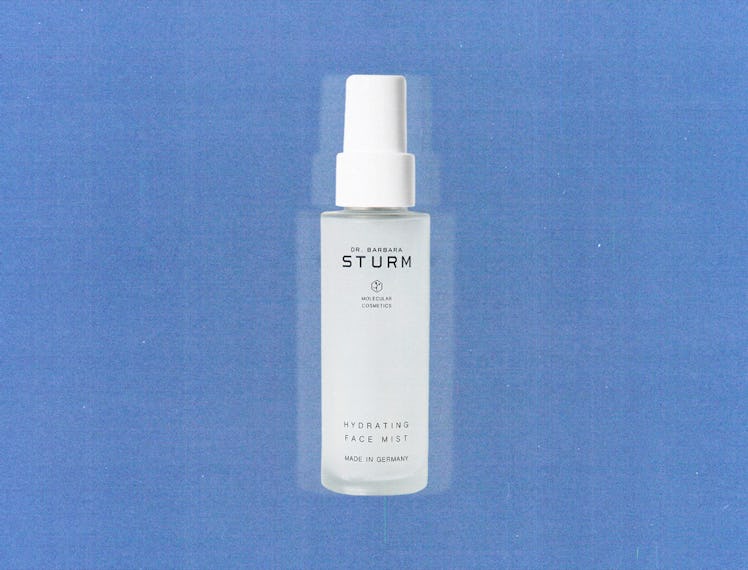 a bottle of Barbara Sturm's hydrating face mist against a blue background