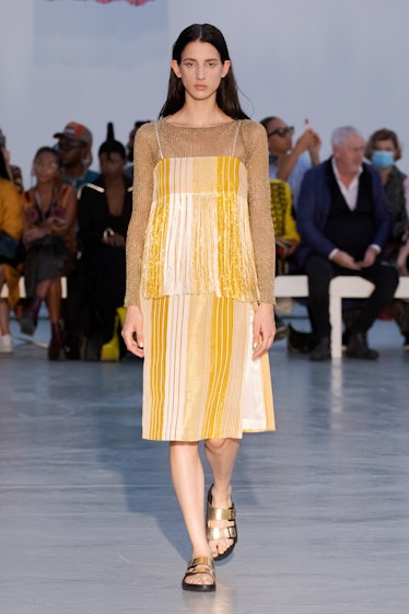 A model walking in a yellow dress by Kenneth Ize on a runway