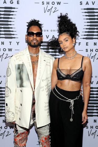 Miguel in a white-black suit and Nazanin Mandi in a black bralette and skirt at the Fenty show