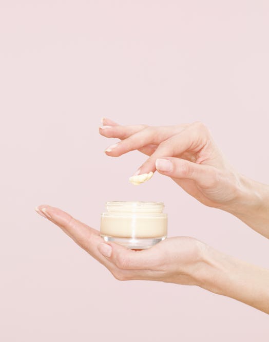 Woman's hand holding a jar of cream
