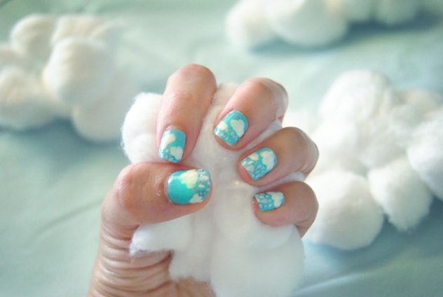Close up of manicured nails with cloud designs 