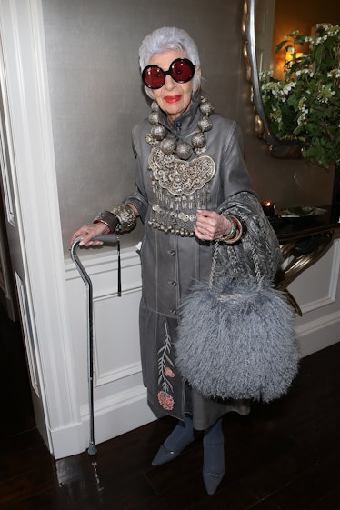 Iris Apfel wearing a grey leather coat