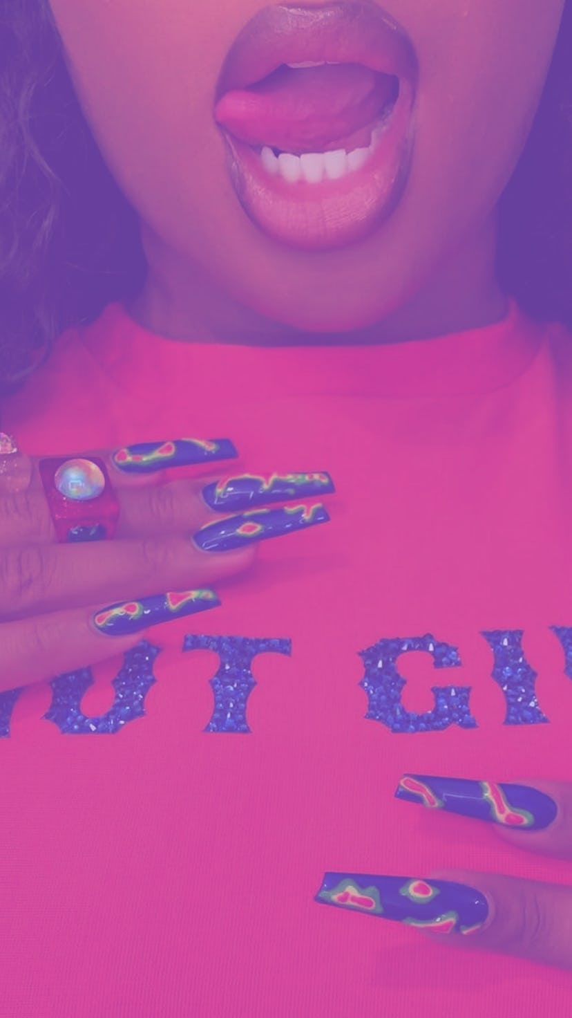 Rapper Megan Thee Stalion wearing an orange shirt with "Hot girl" text on it, and thermal nail manic...