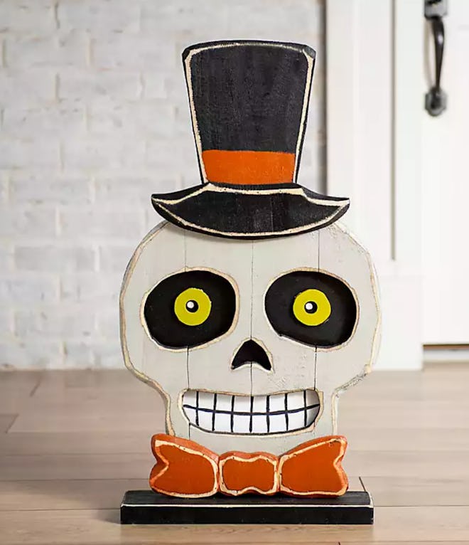 Skeleton head in top hat with bow tie; table decor