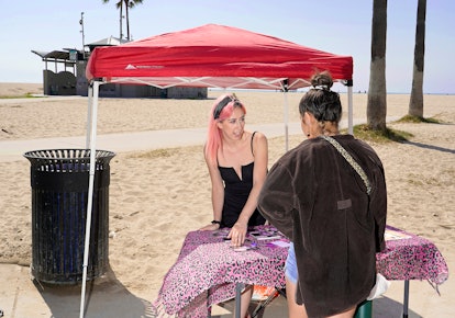 #FreeBritney activist Melanie Mandarano setting up her beach table stand in Venice, California.