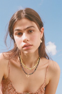 Model wears pieces from Above Average Studio, a jewelry brand like Kendra Scott.