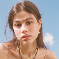 Model wears pieces from Above Average Studio, a jewelry brand like Kendra Scott.