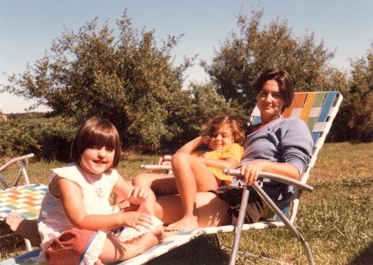 Young Ry, Cade, and Robin sitting in a lawn chair, relaxed and smiling 
