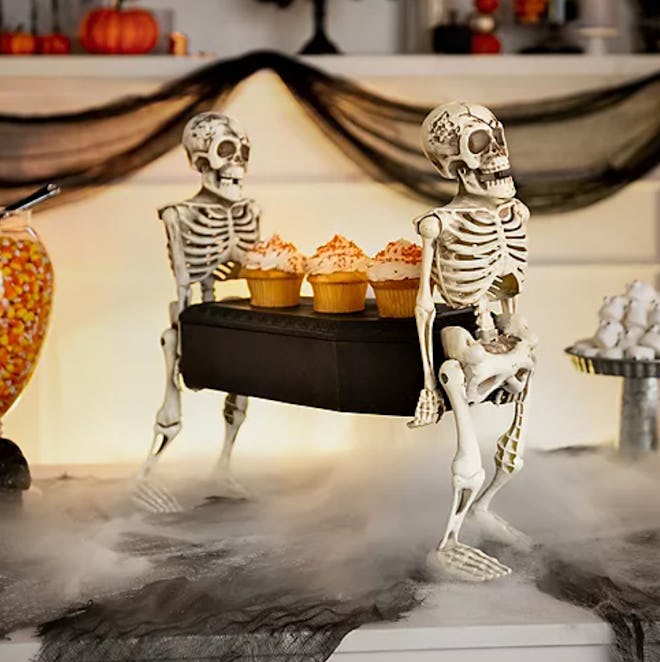 Two skeletons carrying a casket; miniature size, cupcakes on the casket