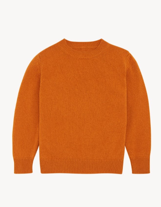 Flay lay of orange crew neck sweater