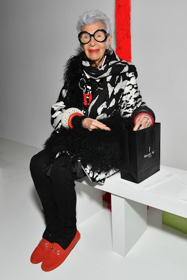 Iris Apfel wearing red shoes at a Calvin Klein show