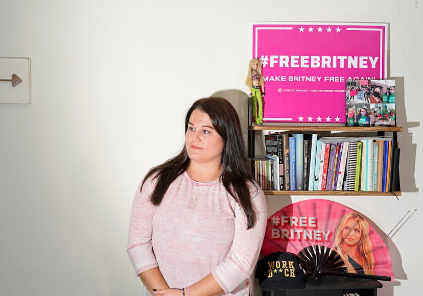 Activist Leanne Simmons standing in a room with all different kinds of posters saying #FreeBritney.