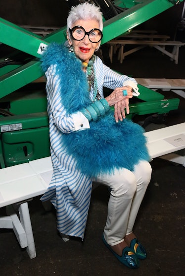 Iris Apfel wearing a blue feather boa