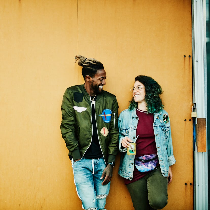 A young pair against a wall, forging a new relationship during the October 2021 new moon in Libra, w...