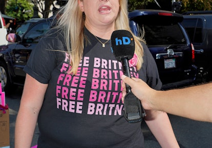A fan with a Free Britney T-shirt speaking to a reporter about Spears' conservatorship case
