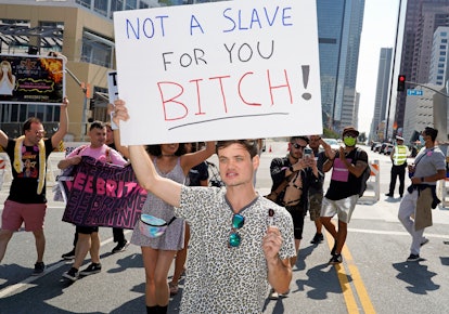 A Britney fan with a banner that says "Not A Slave For You Bitch"