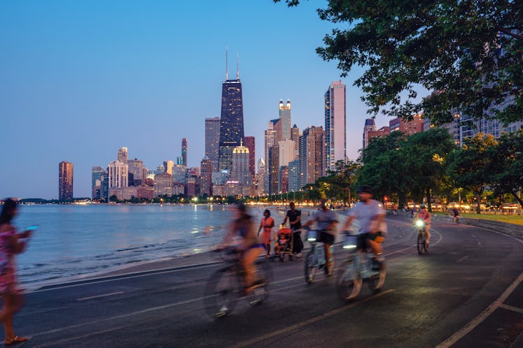 People riding bikes against the Chicago skyline