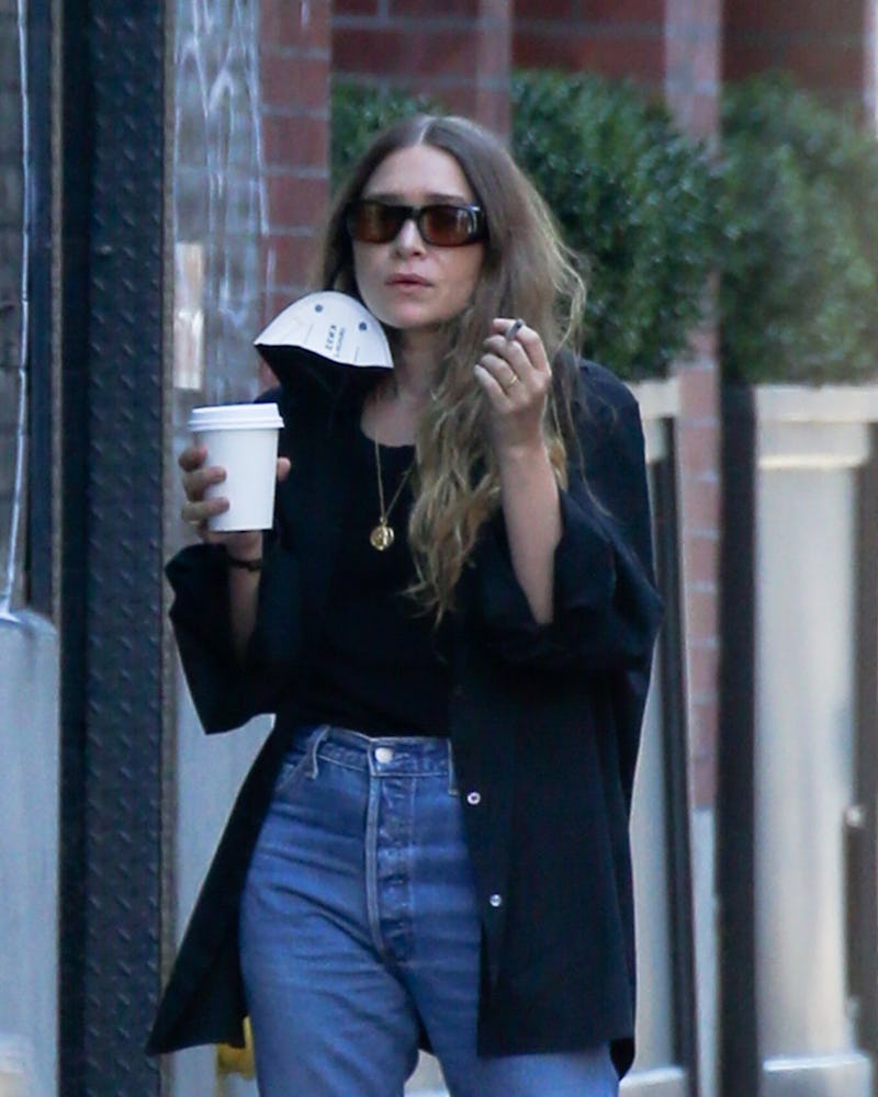 Ashley Olsen wears blue cuff jeans while grabbing coffee in NYC in 2021.