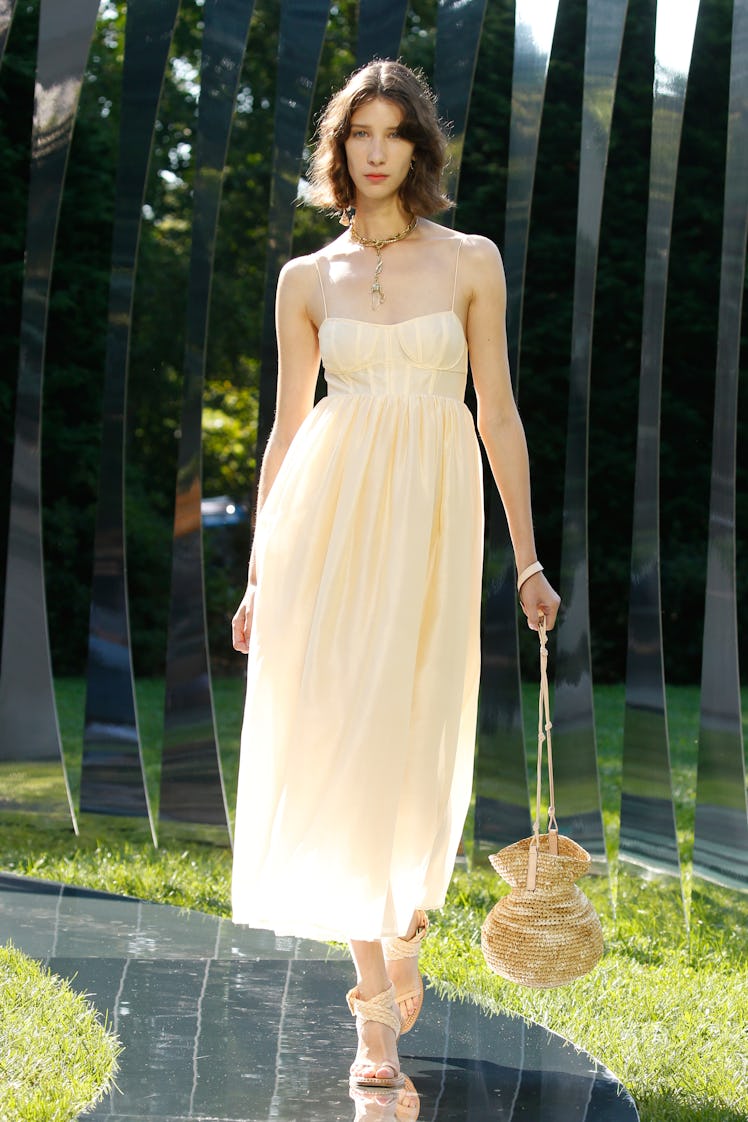 A model walking the runway in a white dress for Ulla Johnson during the NYFW Spring 2022