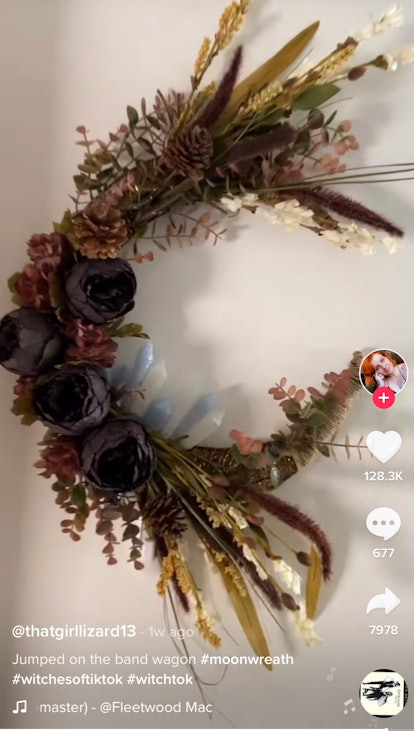 A crescent moon wreath hangs on a wall and is a perfect DIY #WitchTok project from TikTok for the fa...