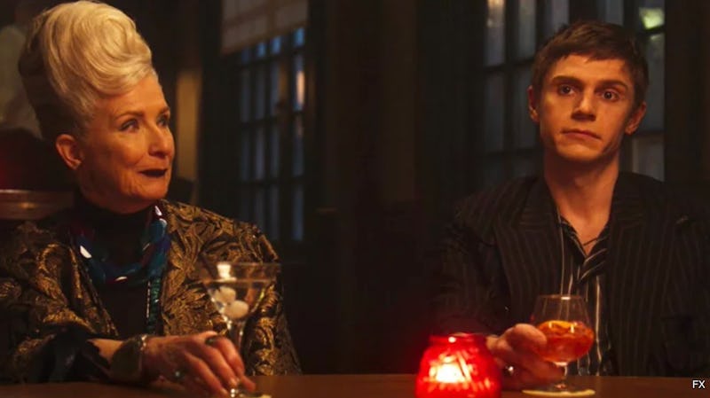 Belle and Austin in the town bar with a red candle in 'American Horror Story: Double Feature'