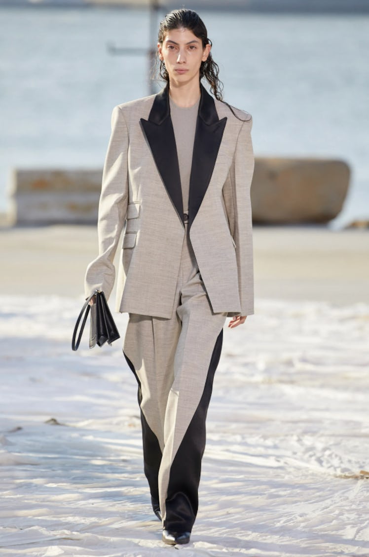 A model wearing a beige suit with black details by Peter Do during the NYFW Spring 2022