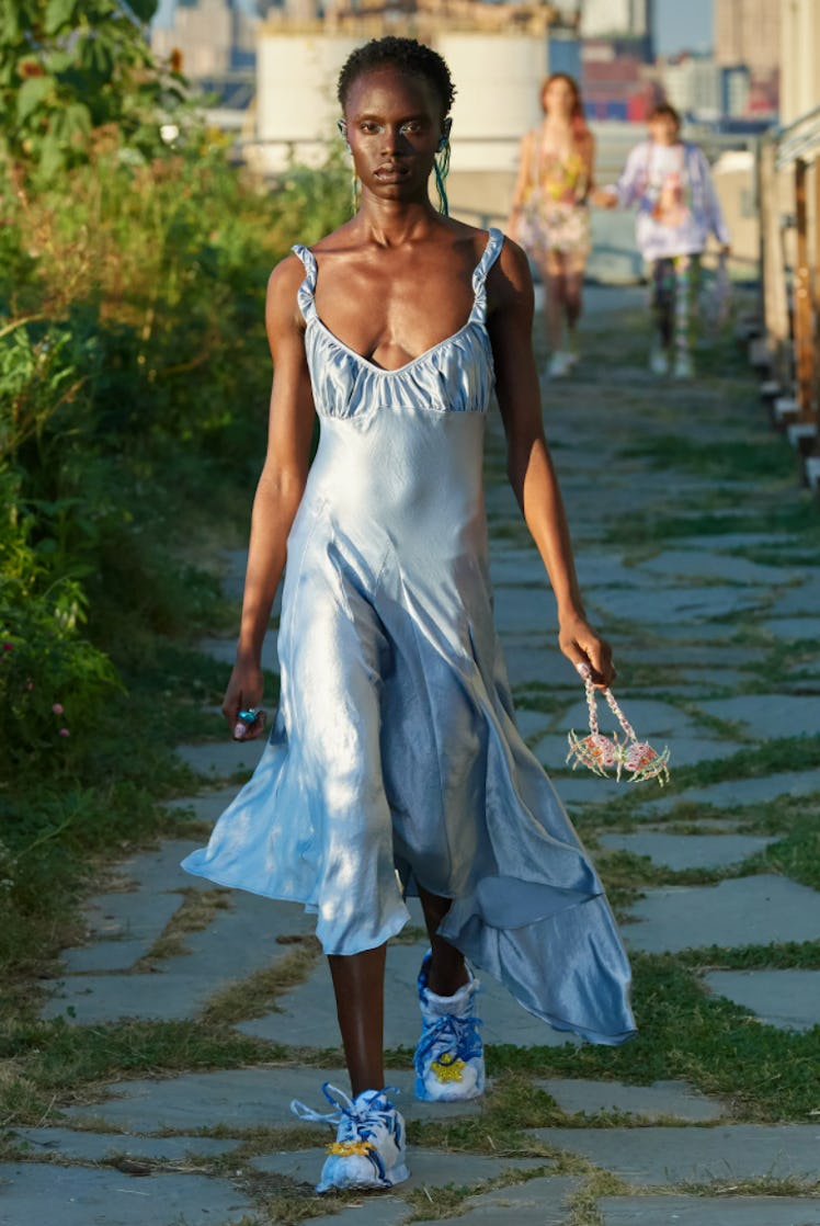 A model wearing a blue satin dress by Collina Strada during the NYFW Spring 2022