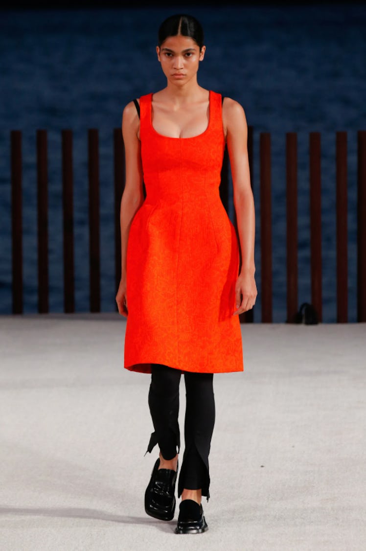 A model wearing a red dress with black pants by Proenza Schouler during the NYFW Spring 2022