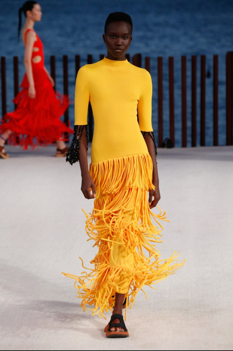 A model wearing a yellow fringed dress by Proenza Schouler during the NYFW Spring 2022