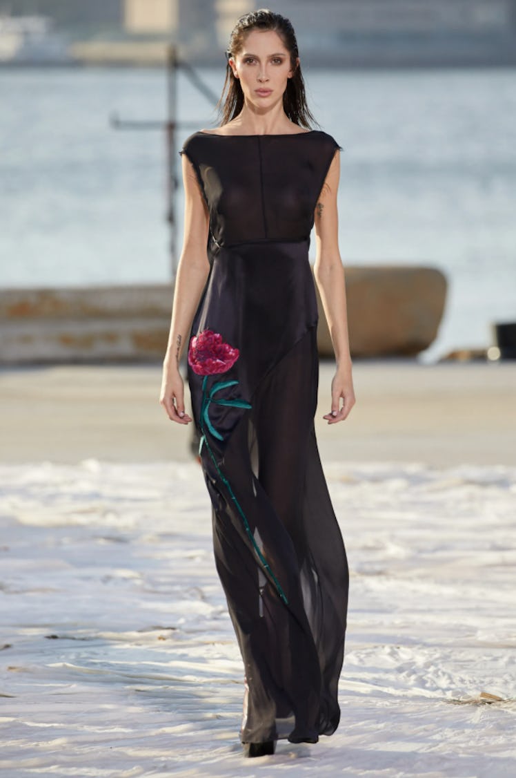 A model wearing a black sheer dress with an embroidered rose by Peter Do during the NYFW Spring 2022