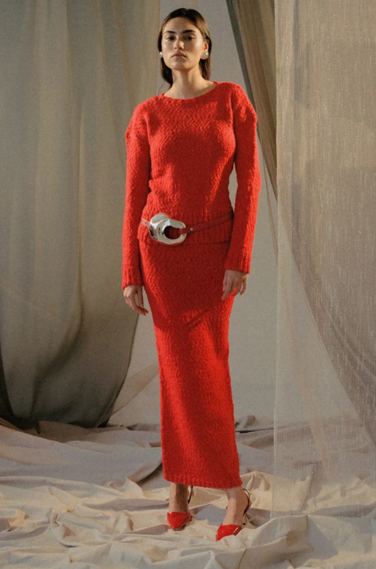 A model wearing a red dress by Alejandra Alonso Rojas during the NYFW Spring 2022