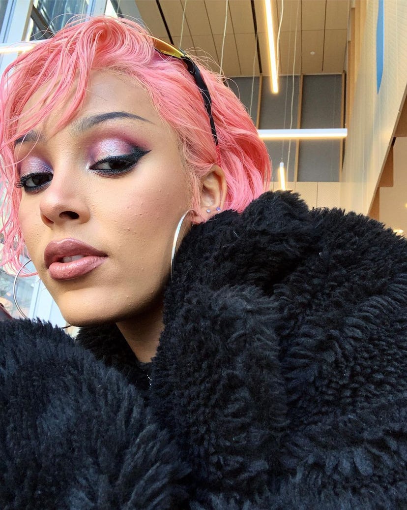 Doja Cat posing with Y2K-style pink hair.