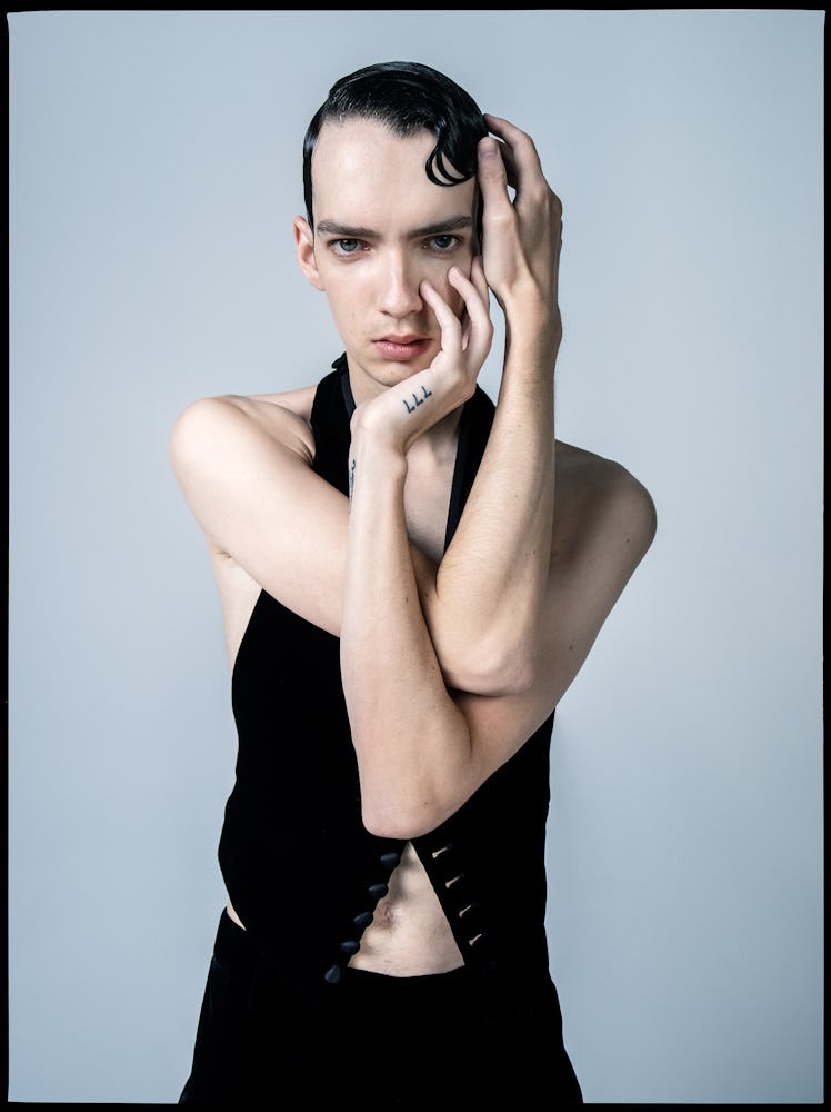 Kodi Smit-McPhee wears a Saint Laurent by Anthony Vaccarello vest and pants.