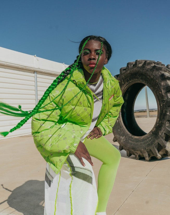 Female model in a green puffer jacket