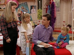 Danny Tanner sits with Michelle, Stephanie, and DJ.