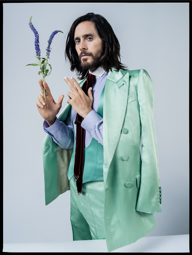 Jared Leto wears a Gucci jacket, vest, shirt, tie, and pants.