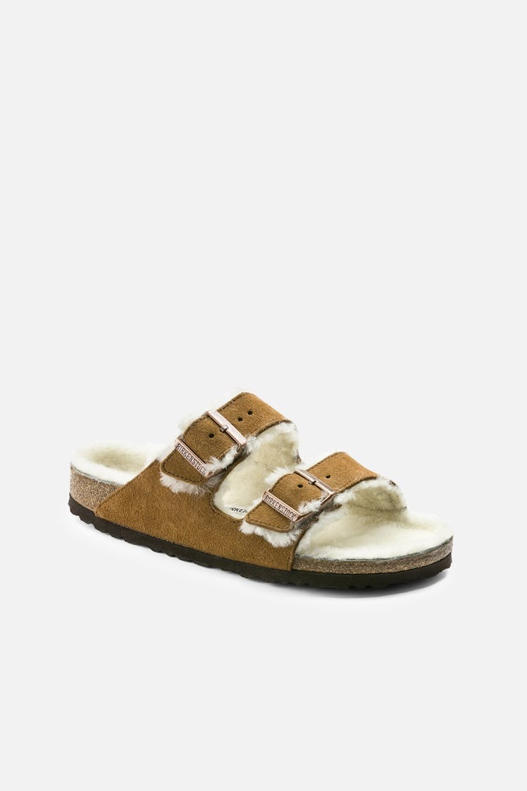 Birkenstock brown shearling slides.