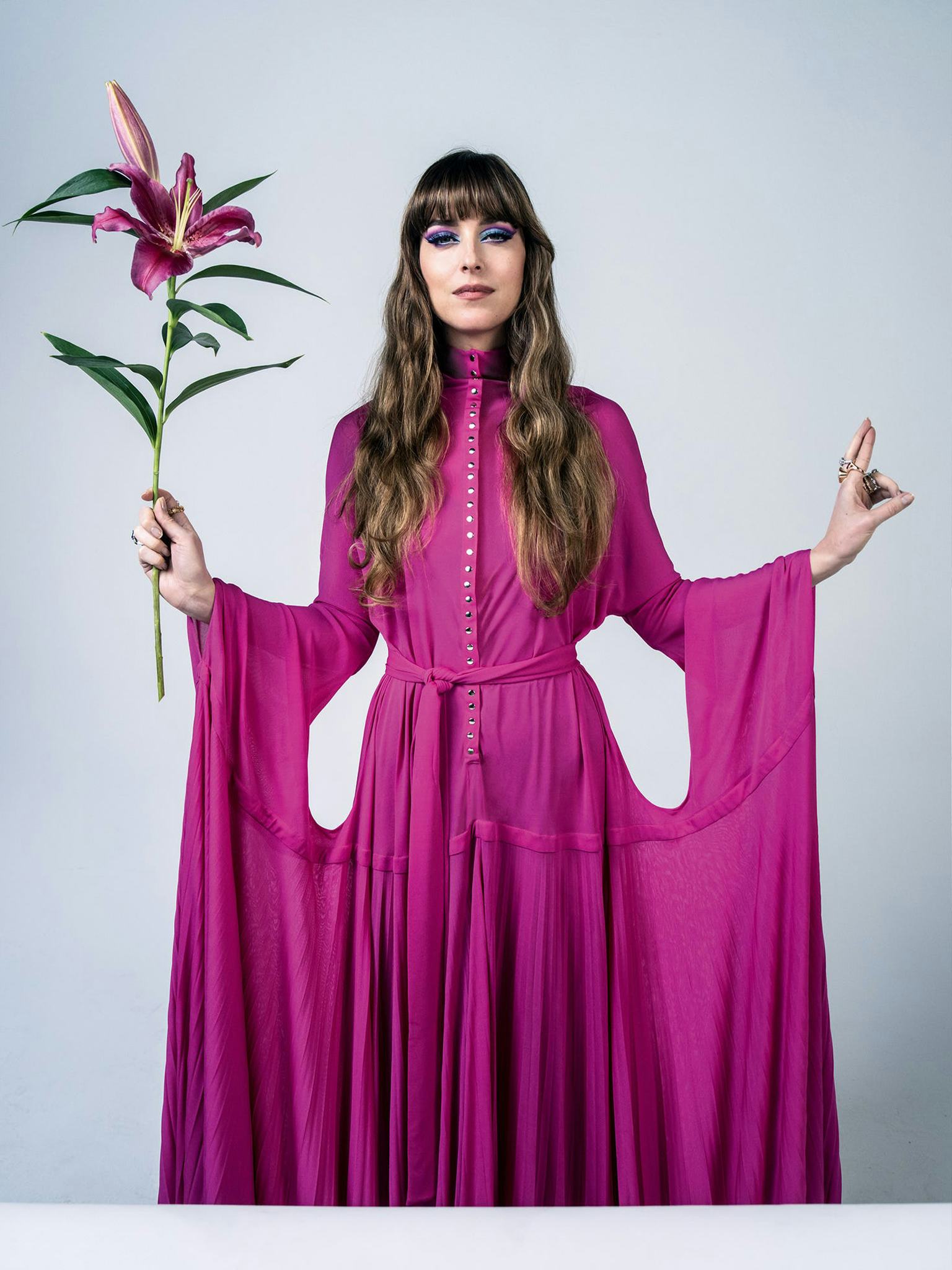 Dakota Johnson in a pink dress holding a flower on the cover of W Magazine's Best Performances