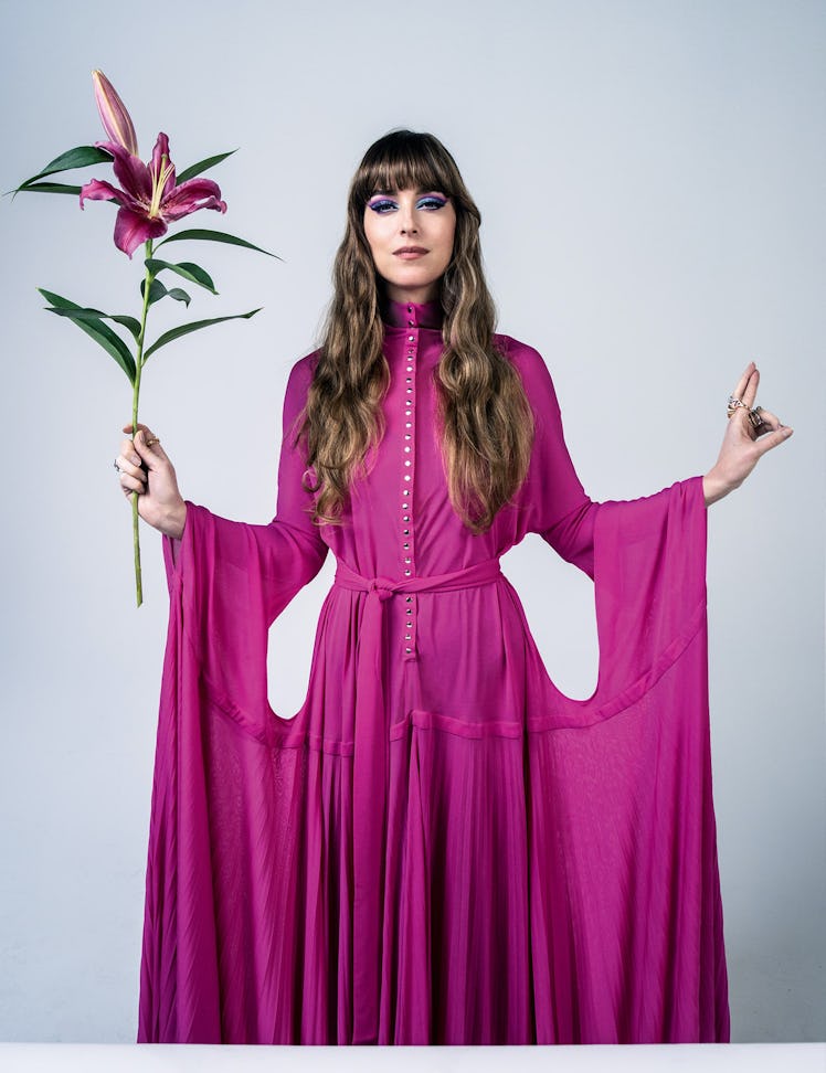 Dakota Johnson in a pink dress holding a flower on the cover of W Magazine's Best Performances