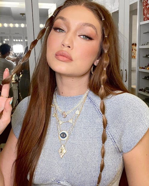 Gigi Hadid in a light blue top with two front bubble braids.