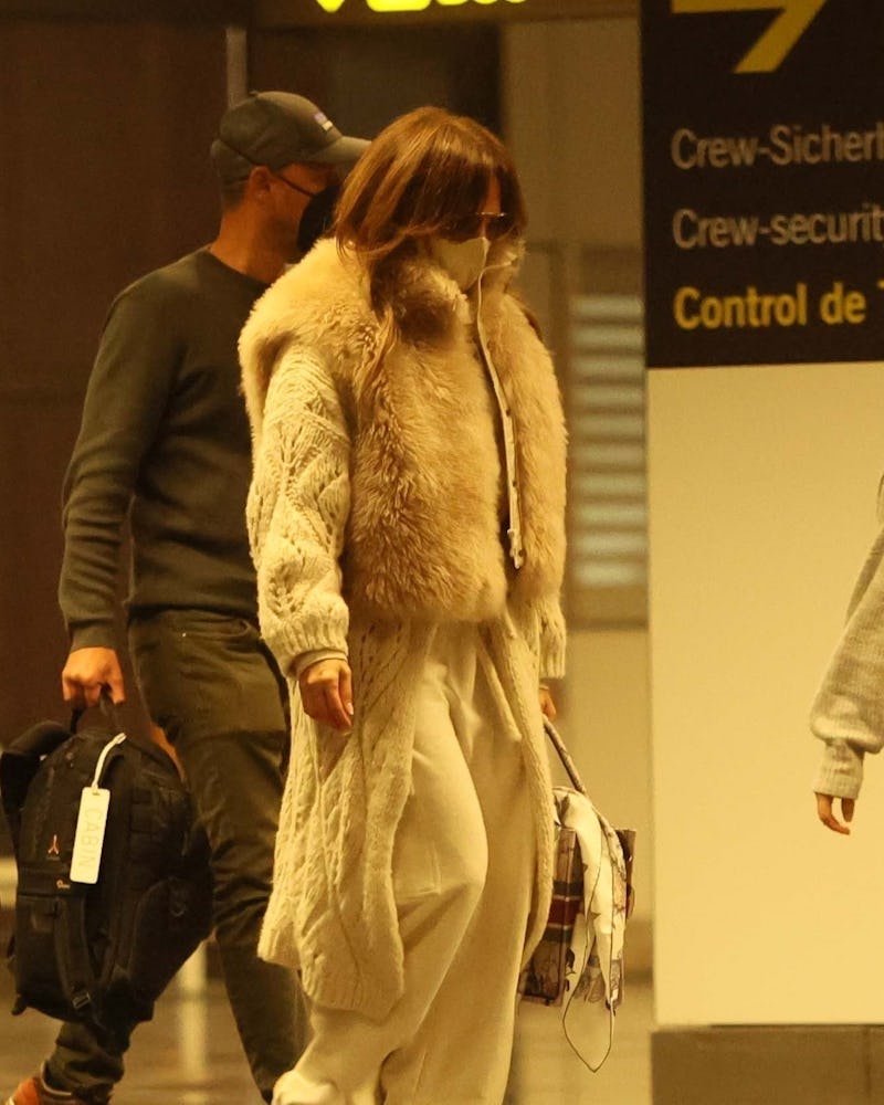 Jennifer Lopez wears Gucci shearling slides.