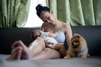 woman in tank top breastfeeding baby 