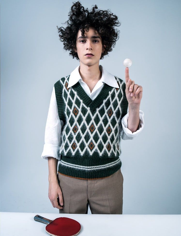 Filippo Scotti in a white shirt, green vest, and brown pants in W Magazine's Best Performances