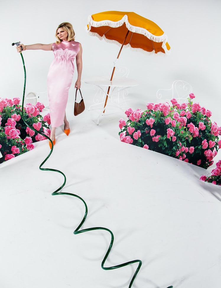Kirsten Dunst in a Prada dress, bag, and shoes watering a garden in W Magazine's Best Performances