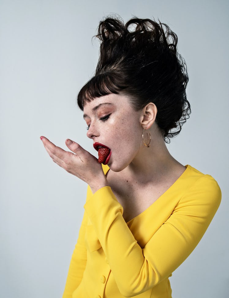 Suzanna Son in a yellow dress eating a strawberry in W Magazine's Best Performances