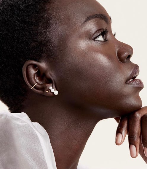 A model wearing Mejuri's Contrast Pearl Climber Studs.