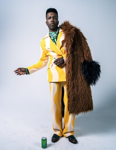 Leslie Odom Jr. in a yellow and white suit, a green shirt, and a brown coat in W Magazine's Best Per...