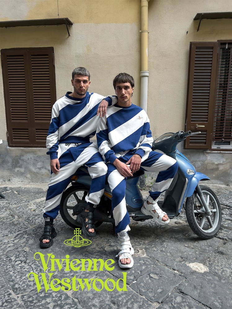 Two people on a motorbike wearing stripes