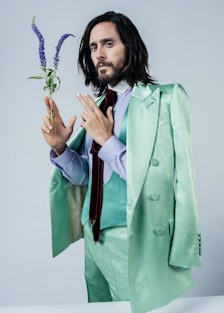 Jared Leto wears a Gucci jacket, vest, shirt, tie, and pants.